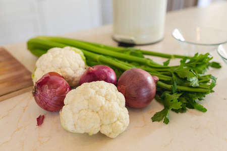Close up of fresh vegetables lying on white countertop in kitchen. cooking and food concept.の写真素材