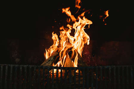 Flames in the hearth of an open fireplace, warming a family home. domestic lifestyle and traditional...