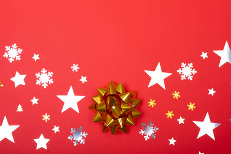 Composition of christmas decorations with stars, snowflakes and copy space on red background. christmas, tradition and celebration concept.の写真素材