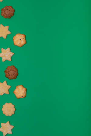 Composition of christmas cookies and copy space on green background. christmas, tradition and...