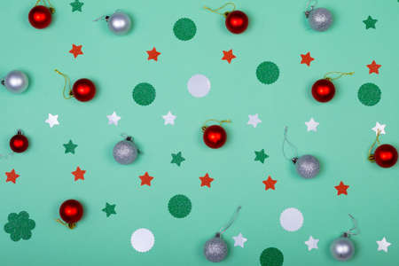 Composition of christmas decorations with baubles and stars on green background. christmas,...