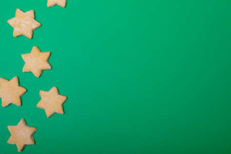 Composition of christmas cookies and copy space on green background. christmas, tradition and celebration concept.の写真素材