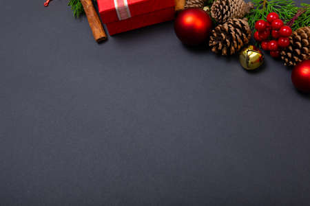 Composition of christmas decorations with baubles, presents and copy space on black background. christmas, tradition and celebration concept.の写真素材