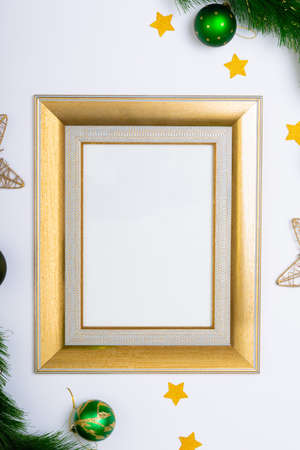 Composition of frame with copy space and fir tree branches with baubles on white background....