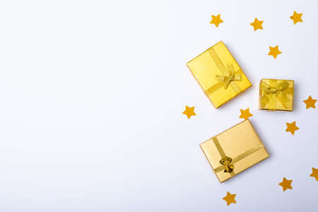 Composition of gold presents with stars and copy space on white background. christmas, tradition and...