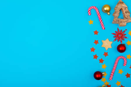Composition of christmas decorations with candy canes and copy space on blue background. christmas, tradition and celebration concept.の写真素材