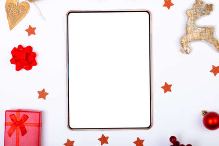 Composition of tablet with copy space and christmas decorations on white background. christmas,...