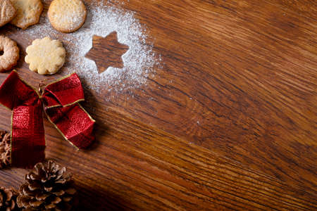 Composition of christmas decorations with christmas cookies and copy space on wooden background. christmas, tradition and celebration concept.の写真素材