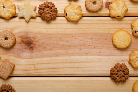 Composition of christmas cookies and copy space on wooden background. christmas, tradition and celebration concept.の写真素材
