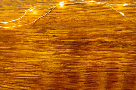 Composition of fairy lights and copy space on wooden background. christmas, tradition and celebration concept.の写真素材