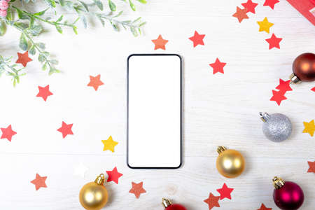 Composition of smartphone with copy space and christmas decorations on white background. christmas,...