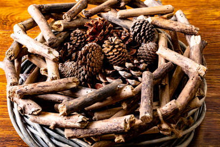 Composition of christmas decorations with sticks and pine cones on wooden background. christmas,...