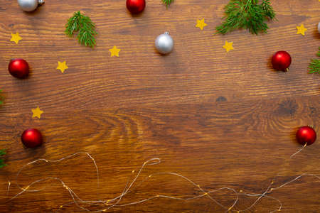 Composition of christmas decorations with baubles and copy space on wooden background. christmas, tradition and celebration concept.の写真素材