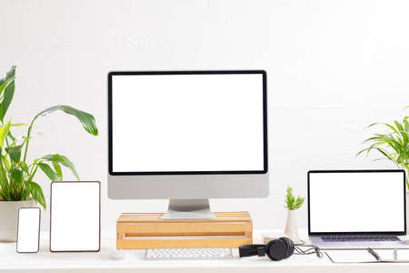 Composition of desktop computer, laptop, tablet and smartphone with copy space on white background....