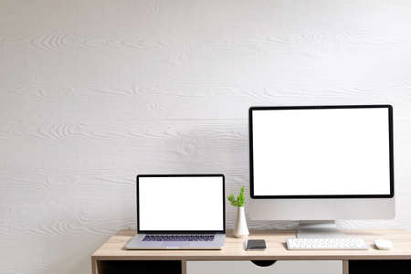 Composition of desktop computer and laptop with copy space on white background. modern office communication and technology concept.の写真素材