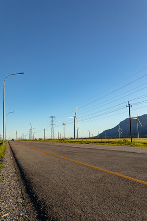 General view of wind turbines in countryside landscape with cloudless sky. environment, sustainability, ecology, renewable energy, global warming and climate change awareness.の写真素材