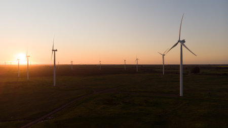General view of wind turbines in countryside landscape during sunset. environment, sustainability,...
