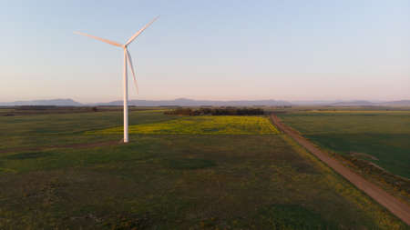 General view of wind turbine in countryside landscape with cloudless sky. environment,...