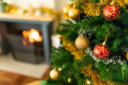 Baubles, chains and other decorations hanging on christmas tree. chiristmas, festivity and tradition at home.の写真素材