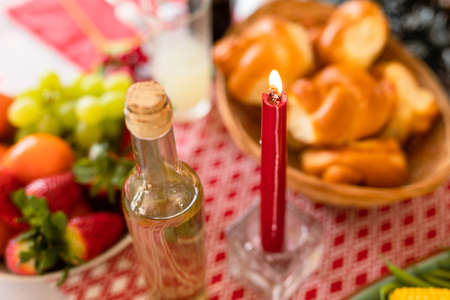 Bottle, candle and traditional dishes lying on christmas table. christmas, festivity and tradition at home.の写真素材