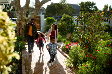 Happy african american family returning back home. family time, having fun together at home and...