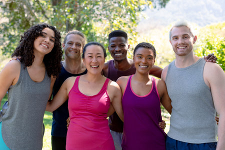 Group of happy fit diverse female and male friends holding yoga mats and taking selfie. fitness and healthy, active lifestyle.の写真素材