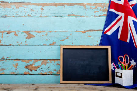 Blank writing slate with copy space by desk organizer on australia flag over table. education and patriotism.の写真素材