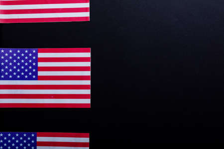 Row of usa flags with stars and stripes by copy space on black background. patriotism, symbol and identity.の写真素材