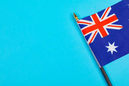 Star and union jack on australia flag stick by copy space over blue background. patriotism, symbol and identity.の写真素材