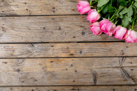 Overhead view of fresh pink tulip flowers bunch over wooden table with copy space. nature and valentine gift.の写真素材