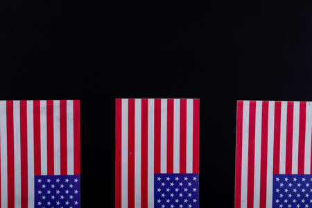 Usa flags with red and white stripes along with stars on black background with copy space. patriotism and identity.の写真素材