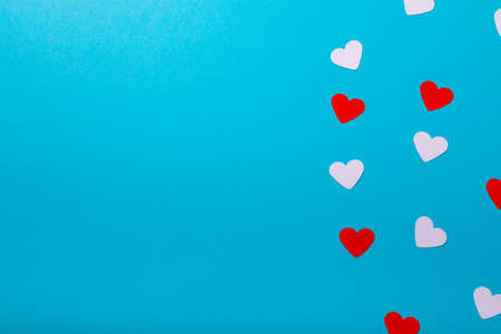 Overhead shot of white and red hearts isolated on blue background with copy space. valentine's day and love concept.の写真素材