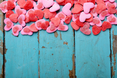 Overhead view of heart shaped pink candies on wooden table, copy space. valentine's day, sweet food and love concept.の写真素材