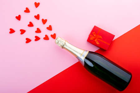 Overhead view of heart shaped decoration with champagne bottle and gift on table, copy space. valentine&#39;s day, drink and love concept.の写真素材