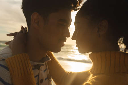 Romantic multiracial couple face to face looking at each other during sunset. lifestyle, love and weekend.の写真素材