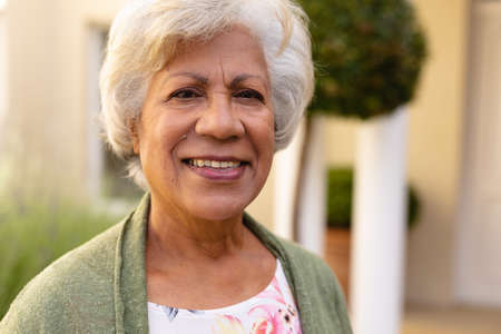 Close-up portrait of african american senior woman smiling while standing outdoors. people and emotions concept, unaltered.の写真素材