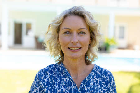 Portrait of caucasian senior woman smiling while standing in the garden. people and emotions...