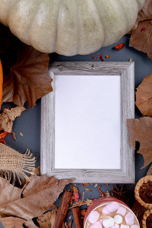 Composition of halloween decoration with pumpkin and frame with copy space on grey background. halloween tradition and celebration concept digitally generated image.の写真素材