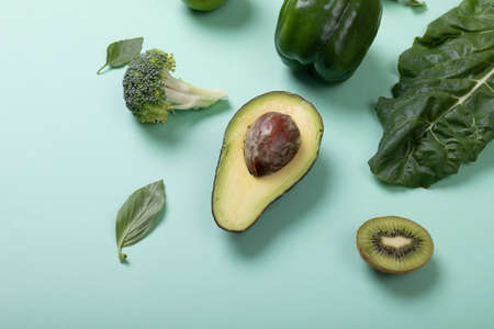 Directly above view of fresh organic fruits and vegetables on green background, copy space. unaltered, food, organic and healthy eating concept.の写真素材