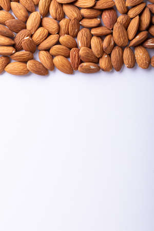 Directly above shot of nutritious almonds on white background with copy space. unaltered, healthy food, copy space, snack, organic, nut and dried food.の写真素材