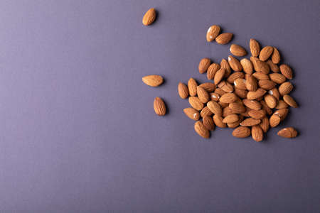 Directly above shot of nutritious almonds on gray background with copy space. unaltered, healthy food, snack, organic, nut and dried food.の写真素材