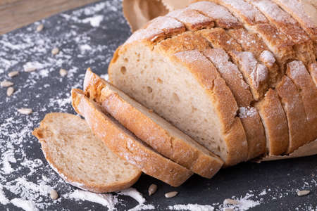 Close-up of sliced bread with flour on food slate. unaltered, healthy food, flour and baked food.