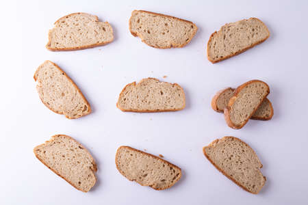 Directly above shot of bread slices arranged on white background. unaltered, healthy food, slice and baked food.の写真素材