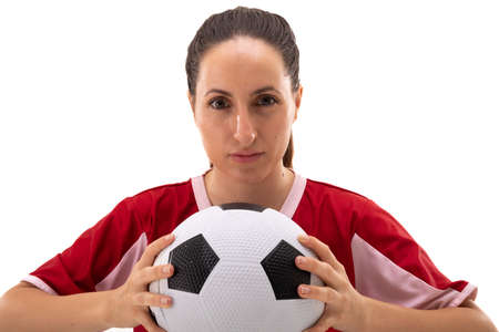 Portrait of caucasian young female soccer player holding soccer ball against white background. unaltered, sport, sports uniform, copy space, athlete and women's soccer.の写真素材