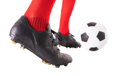 Low section of male caucasian athlete kicking soccer ball over white background. unaltered, sport,...