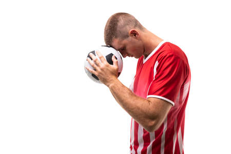 Side view of young male caucasian athlete touching soccer ball on forehead against white background. unaltered, sport, competition and game concept.の写真素材