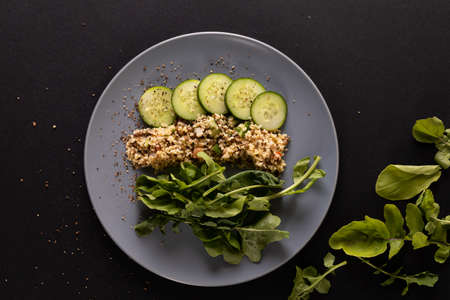 Overhead view of healthy food in plate on black background, copy space. unaltered, food, studio...
