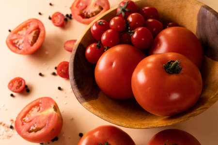 High angle view of fresh tomato variations in bowl by peppercorn on table. unaltered, food, healthy eating, organic concept.の写真素材
