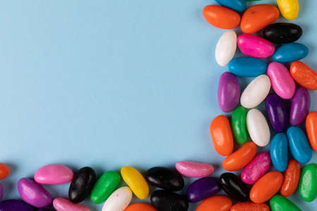 Overhead view of colorful candies and copy space on blue background. unaltered, sweet food and...