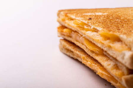 Close-up of fresh cheese toast sandwich served by copy space on white background. unaltered, food, unhealthy eating and snack concept.の写真素材